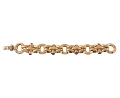  An 18 carat gold ruby and sapphire bracelet,   the hollow links with polished batons set with circular cabochon rubies and s