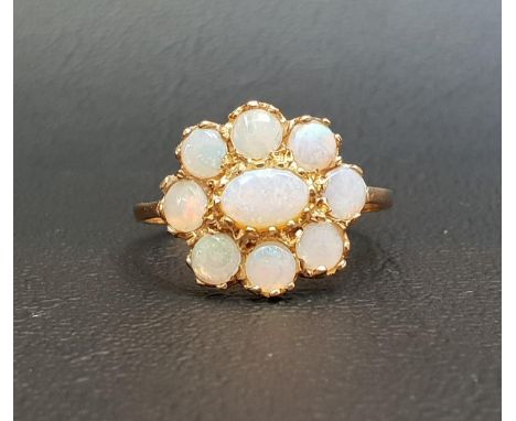 OPAL CLUSTER RINGthe central oval cabochon opal in eight round cabochon opal surround, on nine carat gold shank, ring size N-