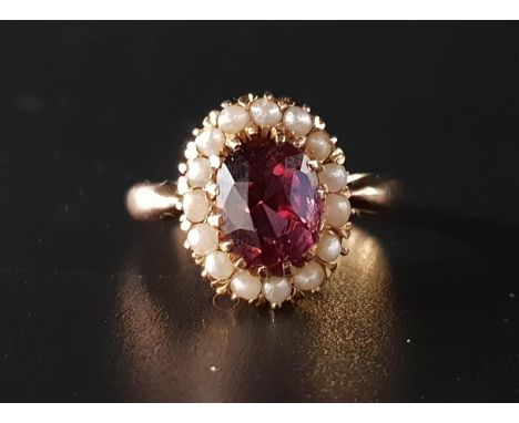 GARNET AND SEED PEARL CLUSTER RINGthe central oval cut garnet approximately two carats in seed pearl surround, on unmarked go