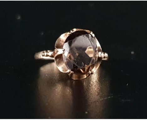 SMOKY QUARTZ SINGLE STONE RINGthe oval cut quartz approximately 2.5cts in pierced and shaped mount, on nine carat gold shank,