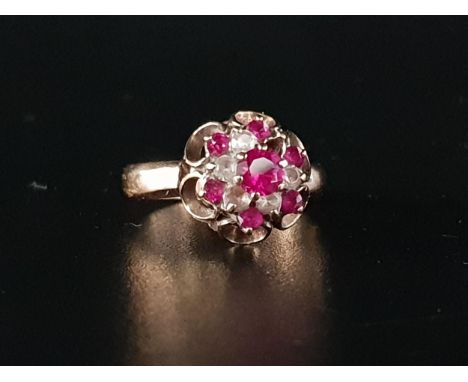 RUBY AND CLEAR GEM SET CLUSTER RINGon nine carat gold shank with pierced mount (one clear gemstone lacking), ring size L-M an