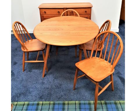 ERCOL BEECH AND ELM DINING ROOM SUITEcomprising a sideboard with two frieze drawers above two panelled cupboard doors, 123.5c