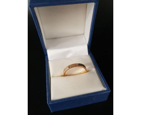 FOURTEEN CARAT GOLD WEDDING BANDwith textured finish, ring size O and approximately 2.5 grams 