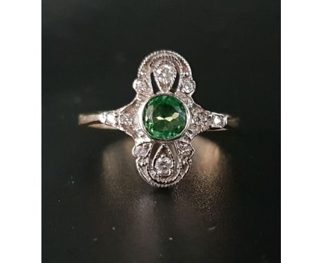 ART DECO STYLE TSAVORITE GARNET AND DIAMOND PLAQUE RINGthe central round cut garnet on diamond set pierced and shaped surroun