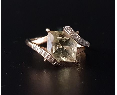 CITRINE AND DIAMOND RINGthe central princess cut citrine in diamond set twist setting overlapping the corners of the citrine,