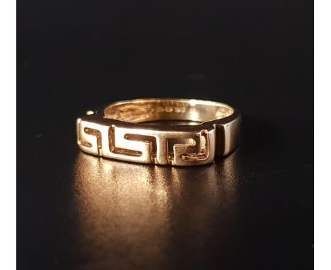 EIGHTEEN CARAT GOLD RINGthe pierced Greek key decoration, ring size N and approximately 4.1 grams 