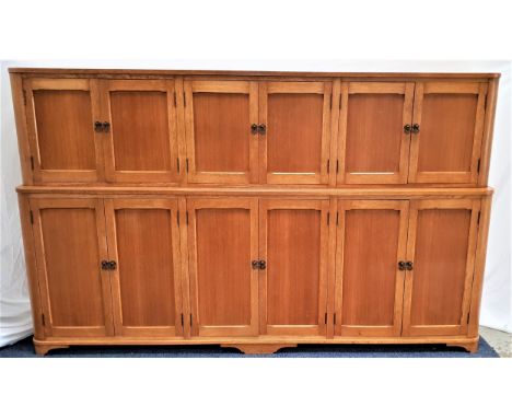 ART DECO HOUSEKEEPERS CUPBOARDin light oak, the upper section with three pairs of panelled cupboard doors opening to reveal s