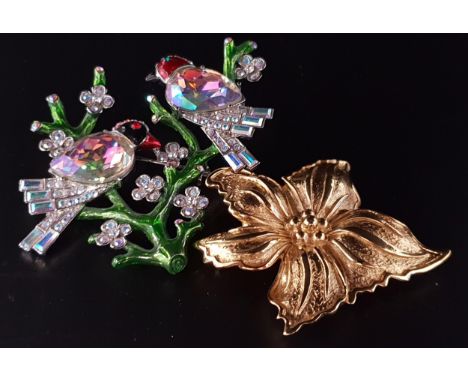 TWO DESIGNER BROOCHESone a Christian Dior gilt flower head; and the other by Butler and Wilson depicting crystal set birds an