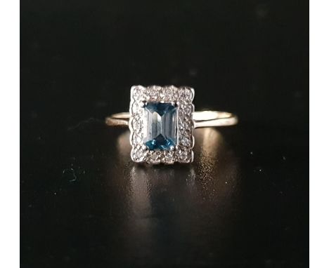 BLUE TOPAZ AND DIAMOND CLUSTER RINGthe emerald cut topaz approximately 0.7cts, in fourteen diamond surround, on unmarked nine