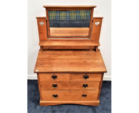 ARTS AND CRAFTS LIGHT OAK DRESSING CHESTwith a rectangular mirror back flanked by a pair of supports with heart motifs above 