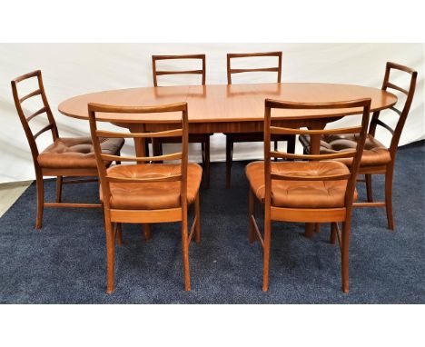 MCINTOSH TEAK EXTENDING DINING TABLEwith an oval pull apart top and fold out leaf, standing on tapering supports, 197cm exten