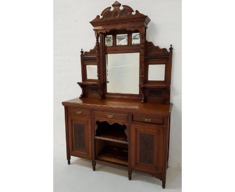 EDWARDIAN OAK MIRROR BACK SIDEBOARDwith a shaped and carved pediment supported by a pair of turned columns above an arrangeme