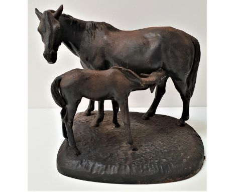 KASLIRussian cast iron model of a mare and foal on a shaped base, signed to the front corner, the underside with foundry mark