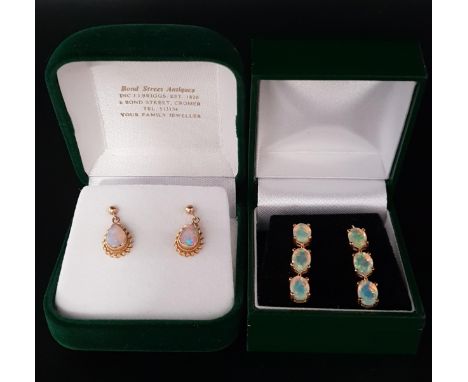 TWO PAIRS OF OPAL SET EARRINGSone pair with three oval cut opals to each earring; the other pair with pear cabochon drops, bo