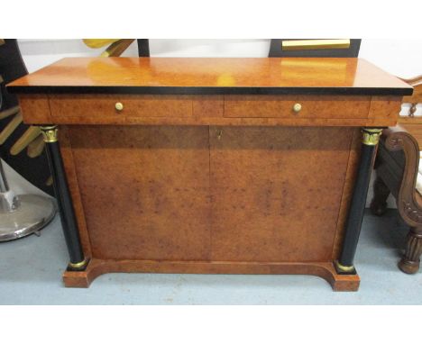 SIDE CABINET, Empire style, with two short drawers over two panelled doors enclosing a shelf flanked by Classical ebonised tu