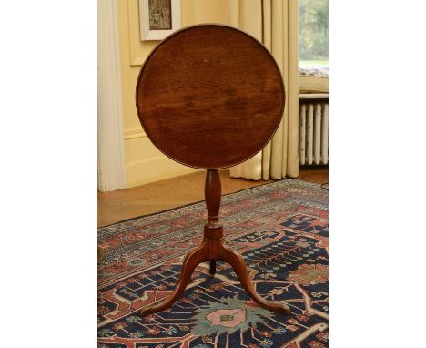 A George III oak occasional table,the dished top on a slender ring turned support and tripod base,48cm diameter67cm highCondi