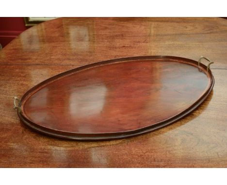 A George III mahogany oval tray,with rosewood crossbanded detail and twin brass handles,77cm wideCondition report: Splits and