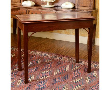 A George III mahogany card table,early 19th century, the baize inset fold-over top, over a concertina action base, raised on 