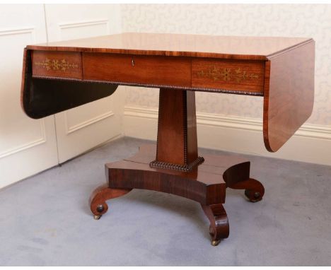 A Regency rosewood sofa table,the drop-flap top on a brass inlaid frieze set with a single drawer, above a bead-decorated spr