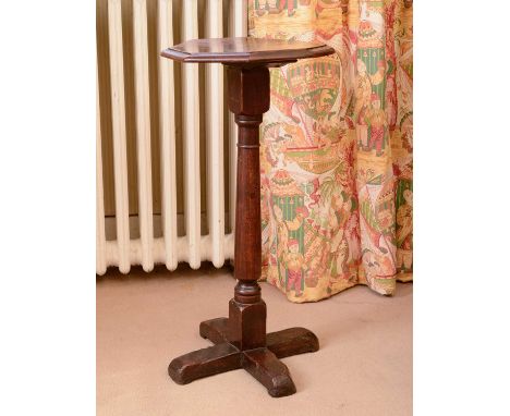 An oak occasional table,19th century, the octagonal top above a ring turned column and quadripartite base,32cm wide65cm highC