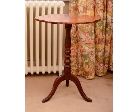 A walnut occasional table,19th century, the shaped oval top above a ring turned column and tripod base,54cm wide40cm deep69cm