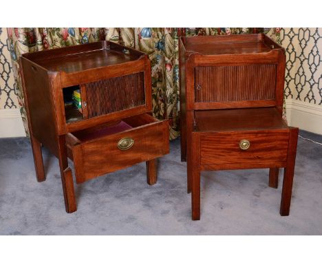 A matched pair of George III mahogany tray top commodes,each with pierced handles to the gallery over a tambour-fronted cupbo