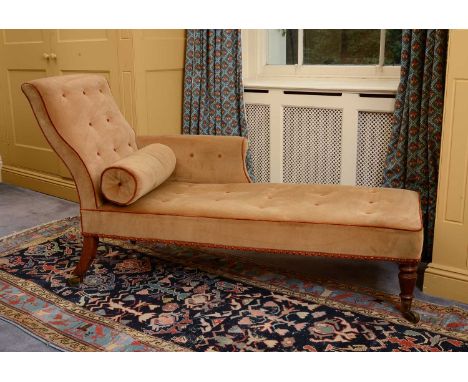 A mahogany chaise longue,early 19th century, the brown velvet, button upholstered, back and seat raised on swept and turned l