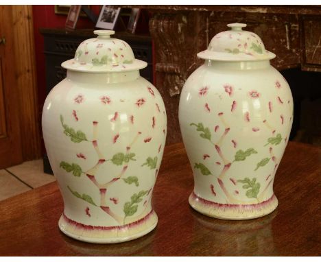 A pair of Chinese porcelain baluster vases and covers,19th century, painted in enamels with blossoming flowers, possibly late