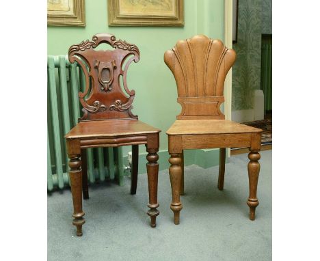 A Victorian mahogany hall chair,with an ornately carved shield-shaped back over a solid seat, on turned legs,43cm wide39cm de