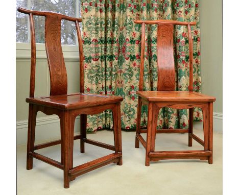 A pair of Chinese elm yoke-back side chairs,20th century, each with a splat back over a solid seat, the legs united by stretc