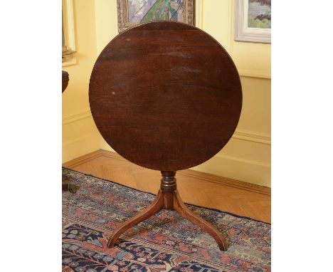 A George III mahogany tilt-top supper table,with a ring turned column support on a tripod base,78cm diameter76cm highConditio