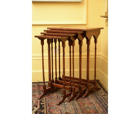 A quartet of Regency-style mahogany tables,20th century, each with quarter veneered and brass inlaid tops, raised on ring tur