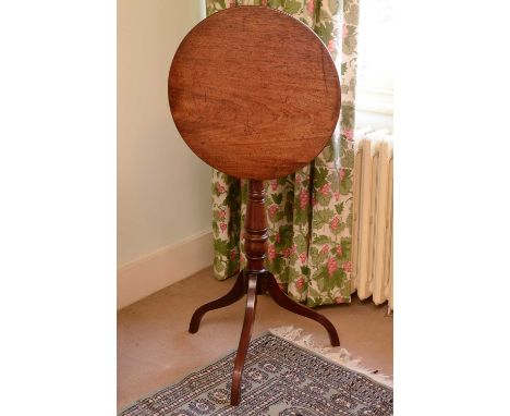 A George III mahogany tilt-top occasional table,with a ring turned support, on a tripod base,48cm diameter78cm highCondition 