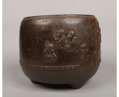 An antique Chinese iron temple censer. Decorated in light relief with daoist immortals and with character marks to the revers