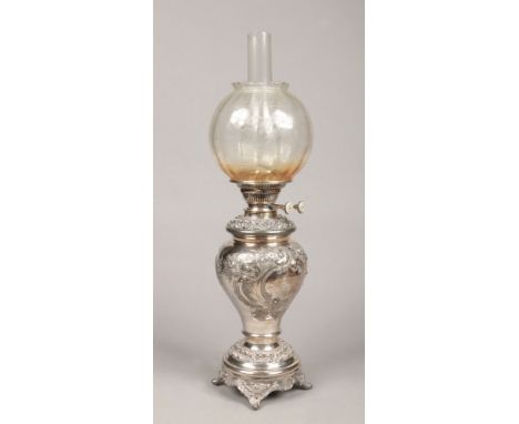 A Victorian silver plated presentation oil lamp by Walker &amp; Hall, Sheffield. With frosted glass shade, having repousse fl