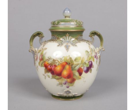 A Royal Worcester twin handled potpourri jar and cover. With pierced collar, moulded with scroll work edged in blue and green