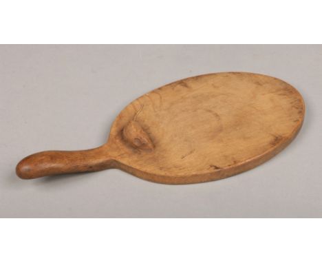 Robert Thompson of Kilburn, North Yorkshire. A Mouseman carved oak cheese board with handle of paddle form. Carved to one sid