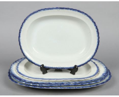 Four late 18th century Ferrybridge serving plates with feather moulded lobed rims edged in underglaze blue along with a simil