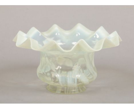 A Victorian vaseline glass oil lamp shade. Moulded with flowers and with frilled rim, 26cm wide, 13.5cm high. Rim 9.75cm diam
