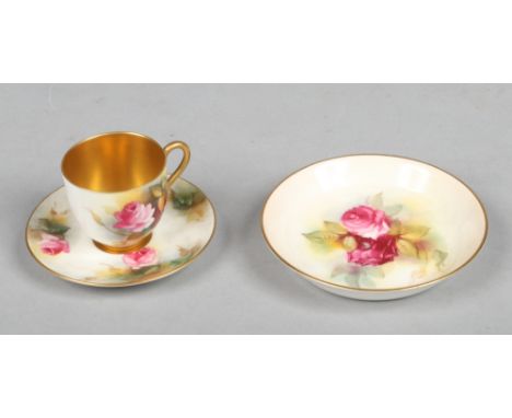 A Royal Worcester small coffee cup and saucer with gilt interior and painted with roses, signed M. Hunt along with a similar 