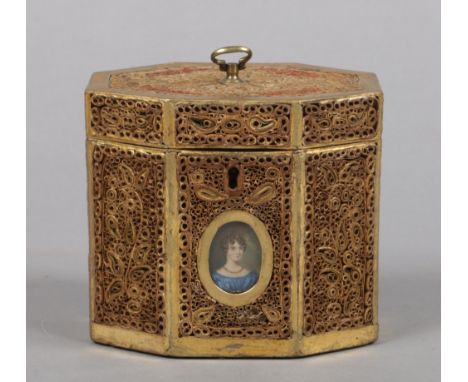 A Regency tea caddy of canted rectangular form. Decorated with panels of rolled paper and set with a portrait miniature of a 