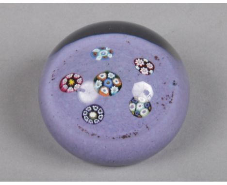 A Paul Ysart paperweight set with five complex canes on a lilac speckled ground, Harland period, 7.25cm wide.&nbsp;Condition 