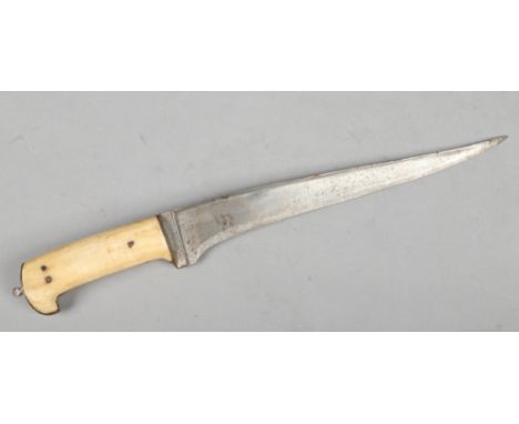An eastern hunting knife with bone scales, 39cm.Condition report intended as a guide only.Pitted.&nbsp;