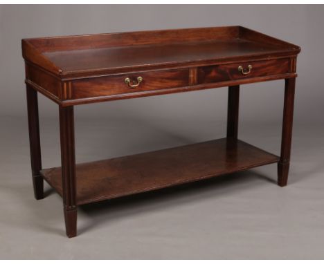 A George III mahogany two tier serving table with oak drawer linings. With a pair of frieze drawers, reeded inlays and carved