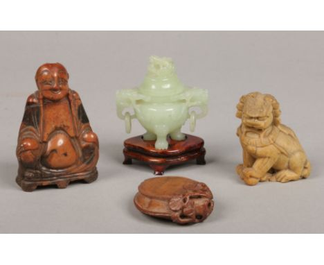 A small Chinese carved celadon jade censor and cover raised on a hardwood plinth, two carved soapstone figures and a carved s