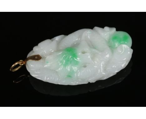 A Chinese white jade pendant with spinach green suffusion and 14 carat gold clasp. Finely carved with a dragon and with cloud