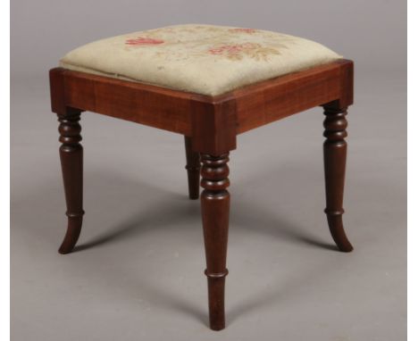 A Regency mahogany stool with needlepoint inset seat. Raised on ring and bobbin turned supports with splay feet. Frame 44cm x