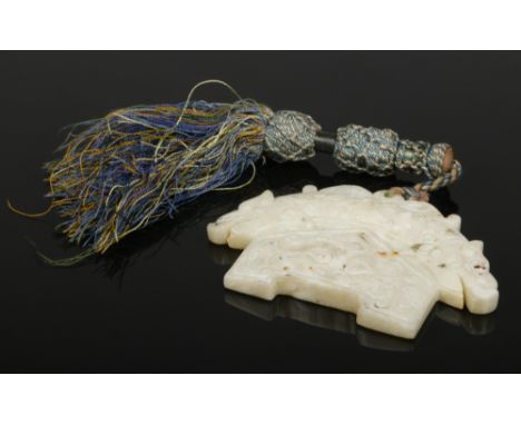 A Chinese archaistic opaque pale celadon jade carving. Decorated with mythical beasts and a mask, 9.25cm wide.&nbsp;Condition