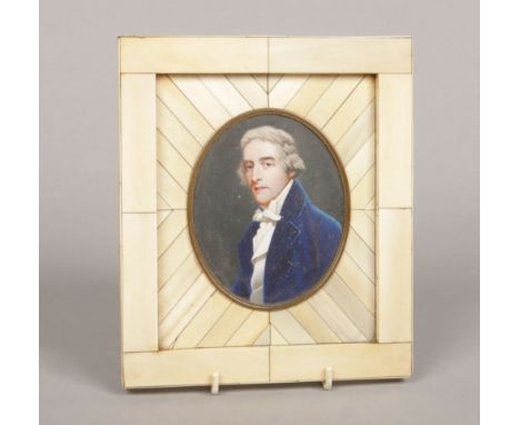 An ivory portrait miniature of a gentleman wearing a blue overcoat and cravat in large piano key frame. Signed Ziegler, paint