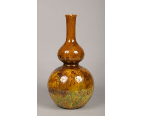 A large Victorian Art pottery vase of double gourd form. Decorated in green, yellow and brown glazes in the Burmantofts style